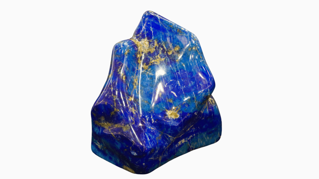 A polished, irregularly shaped blue stone with gold and white streaks, reminiscent of Reiki crystals, set against a dark background. Perfect for those embarking on a healing journey.
