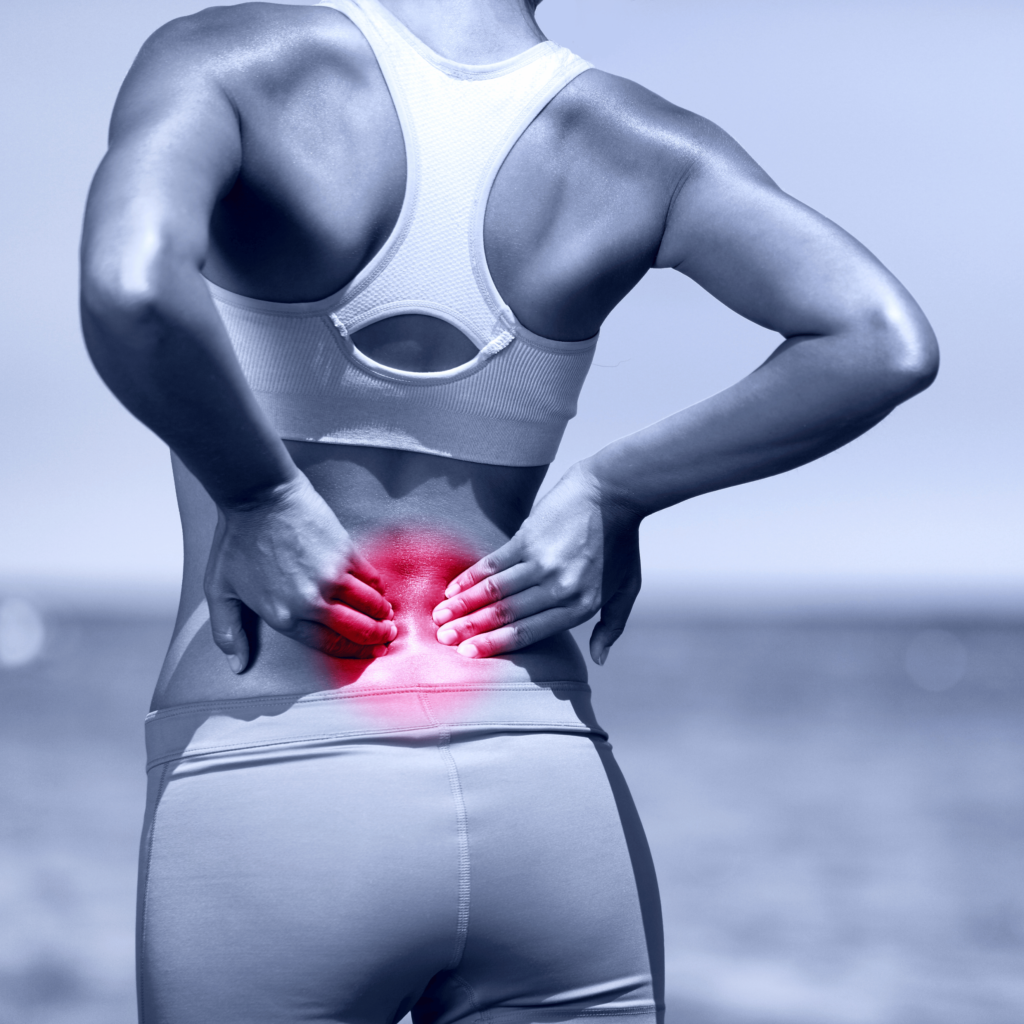 A woman in athletic wear holds her lower back, highlighting pain with a red area.